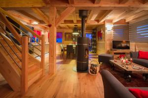 a living room with a fireplace in a log house at CHALET L'ALPAGA 1 in Les Deux Alpes