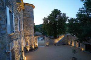 an empty courtyard of a building with an archway at Château De Chaussy in Ruoms +187 photos