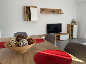 a dining room table with a bowl of balls on it at Balcescu Apartment Self Check-in in Timişoara