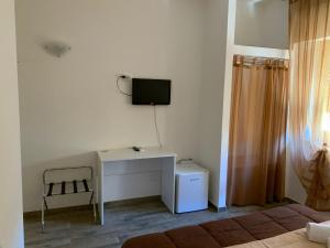 a room with a desk and a tv on the wall at BONORUM De Spuches in Palermo