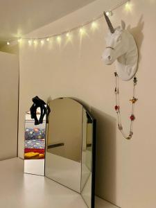 a mask of a horse hanging on a wall next to a mirror at Cosy Cottage in Durham City in Durham