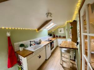 a kitchen with a sink and a counter top at Cosy Cottage in Durham City in Durham
