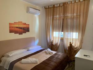 a bedroom with a bed and a window at BONORUM De Spuches in Palermo