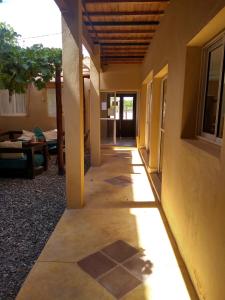 a hallway of a house with the sun shining on it at La Morada Hostal in Cafayate