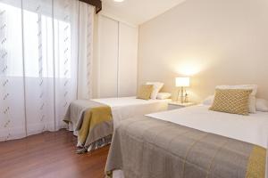 Posteľ alebo postele v izbe v ubytovaní Exclusive Apartments Street Beatas