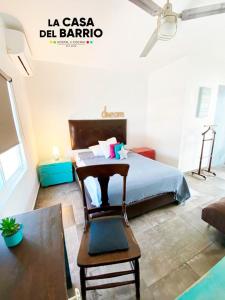 a bedroom with a bed and a chair and a table at La Casa del Barrio in Monterrey