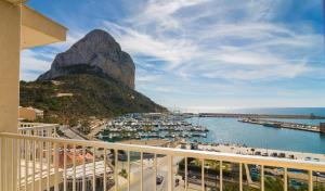 a balcony with a view of a harbor and a mountain at Hotel Porto Calpe in Calpe