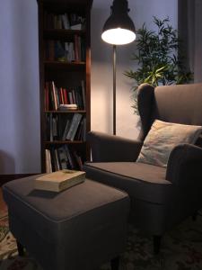a living room with a couch and a chair and a book at Hotel Rural da Ameira in Montemor-o-Novo