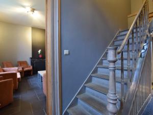 a staircase in a room with a couch and a stair case at Lavish Holiday Home in Durbuy with Garden in Durbuy