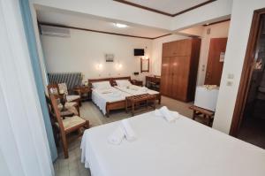 Ένα ή περισσότερα κρεβάτια σε δωμάτιο στο Ξενοδοχείο Βλαχογιάννης