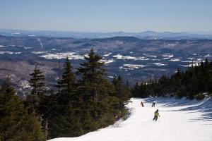 a group of people skiing down a snow covered slope at Kimpton Taconic Hotel, an IHG Hotel in Manchester