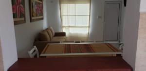 a living room with a couch and a table at Jenaz in Federación
