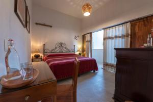 a hotel room with two beds and a television at La Casa Carlota in Oaxaca City