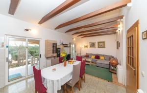 a kitchen and living room with a table and chairs at House Mare in Kastel Novi
