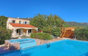 a large swimming pool in front of a house at House Mare in Kastel Novi
