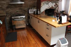 a kitchen with a counter top and a stove top oven at Bakehouse Burra in Burra