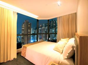 a bedroom with a large bed and a large window at Bishop Lei International House in Hong Kong