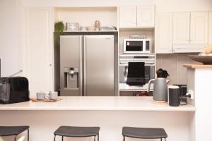 a kitchen with a stainless steel refrigerator at The Glen Farmhouse on Ovens River in Wangaratta +52 photos