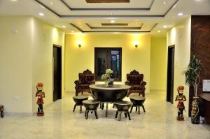 a lobby with a large round table and chairs at Ganga Monastery in Varanasi