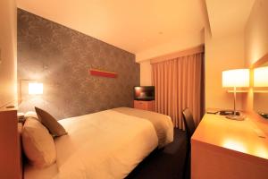 a hotel room with a bed and a desk at Richmond Hotel Tokyo Shiba in Tokyo