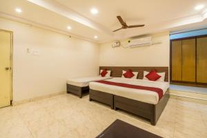 a bedroom with two beds and a ceiling fan at Hotel Siri Grand in Visakhapatnam