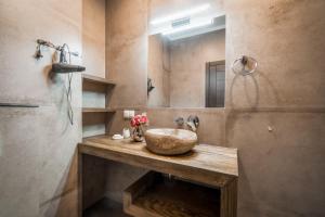 a bathroom with a stone sink and a mirror at Villa Aquamarin Buhaz in Zatoka +53 photos
