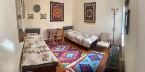 a living room with a bed and a table at Art Guest House USTO in Bukhara