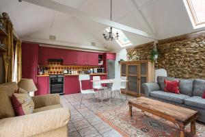 a living room with a couch and a table at The Old Stables in Docking