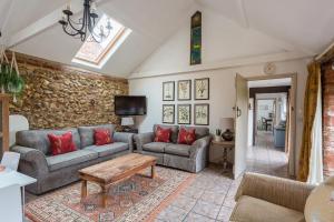 a living room with two couches and a table at The Old Stables in Docking