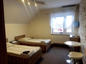 a room with two beds and a window at Noclegi i Restauracja Gracja in Bełchatów +59 photos