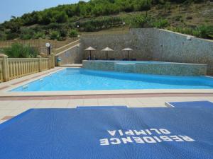 a large swimming pool with a blue mat on the ground at Residence Olimpia in Peschici