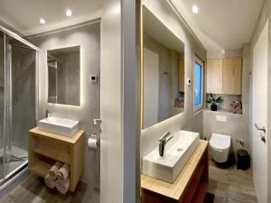 a bathroom with two sinks and a shower and a toilet at MarinaVilla in Nykøbing Falster +37 photos