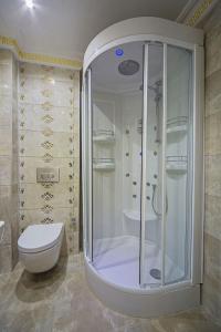 a bathroom with a shower and a toilet at Lausos Palace Hotel Şişli in Istanbul