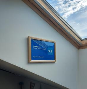 a skylight in a house with a window at Apartman Santorini in Novi Sad