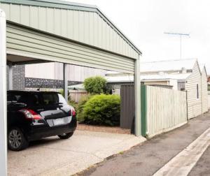 a car parked in front of a garage at Quartz Cottage Geelong in Geelong
