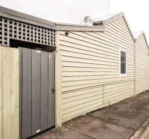 a building with a garage with a door at Quartz Cottage Geelong in Geelong