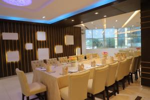 a long dining room with a long table and chairs at Hotel Valley Garden in Sylhet