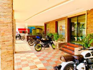 a group of motorcycles parked in front of a building at Hotel Half Moon Chennai in Chennai