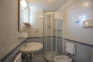 a bathroom with a sink and a shower at Hotel Caravelle in Pesaro +18 photos