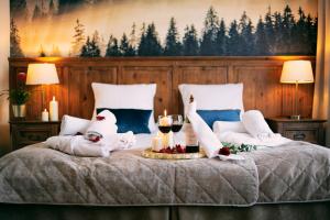 a bed with christmas decorations and candles on it at Hotel Kotarz Spa&Wellness in Brenna