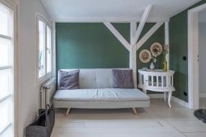a living room with a couch and a table at Altes Kontorhaus Backbord in Husum