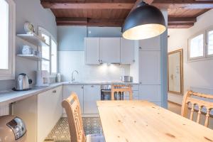 a kitchen with a wooden table and a dining room at Altes Kontorhaus Steuerbord in Husum