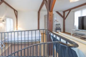 a spiral staircase in a room with a television at Altes Kontorhaus Steuerbord in Husum