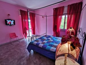 a bedroom with a bed and red curtains at Tea Versilia - Forte dei Marmi in Forte dei Marmi
