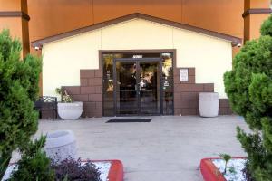 an entrance to a building with an open door at Days Inn & Suites by Wyndham Houston North/Aldine in Houston