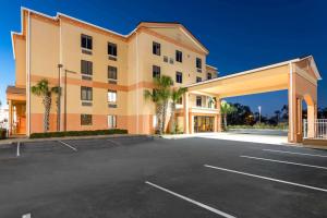 a large office building with a parking lot at Ramada by Wyndham Panama City in Panama City