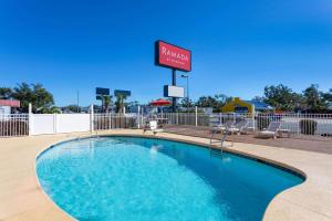 a swimming pool at a hotel with a sign at Ramada by Wyndham Panama City in Panama City
