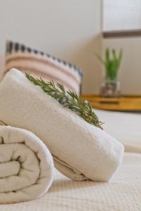 a towel with a plant on top of it on a table at Kalimera Karpathos Exclusive Villas in Afiartis