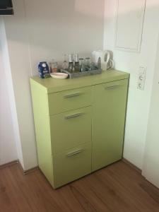 a yellow cabinet with a sink in a room at Schmitten Haus in Zell am See