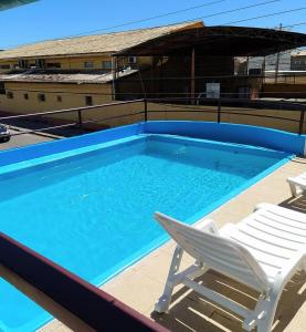 a large swimming pool with a chair and avisorvisorvisor at Hotel Sol Bahia in Porto Seguro